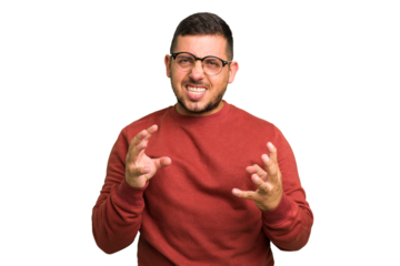 Young caucasian man isolated upset screaming with tense hands.