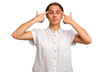 Young caucasian woman isolated focused on a task, keeping forefingers pointing head.