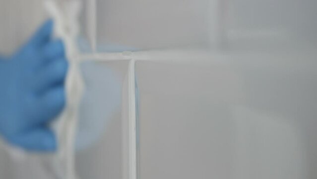 Blurred Shooting with a Man Wearing Gloves in Hands and Cleaning the Bathroom Faience. Household Chores, Cleaning and Sanitizing the Faience in the Kitchen.