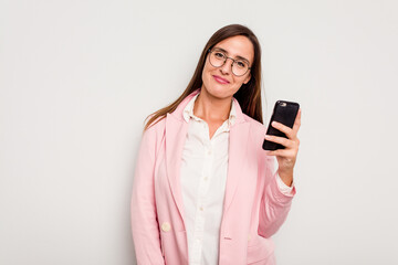 Fototapeta premium Business caucasian woman holding a mobile phone isolated on white background happy, smiling and cheerful.