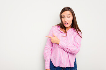 Young caucasian cute woman isolated on white background smiling and pointing aside, showing something at blank space.