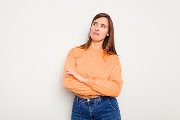 Young caucasian cute woman isolated on white background dreaming of achieving goals and purposes