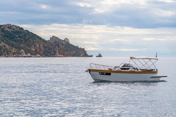 Little luxury boat sailing near the line coast