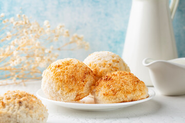 Coconut macaroons, small cake or biscuit, cookies. Morning table. White and light blue background.