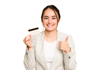 Young caucasian woman holding a credit card isolated on green chroma background smiling and raising thumb up