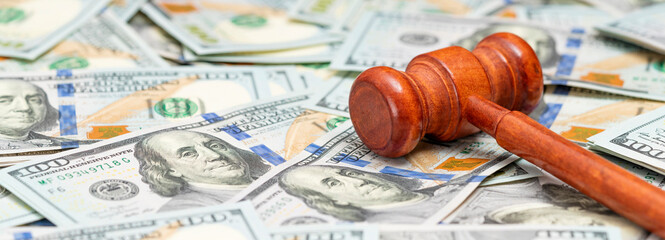 Judge gavel on American money background. Fraud tax fines. Law, judgment and justice concept. Banner