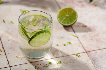 Tasty refreshing drink with lime, ice and sparkling water