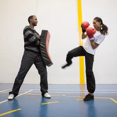 Foto op Aluminium Sports Students: Kickboxing. A teenage girl learning self-defence skills under the supervision of her teacher. From a series of related images. © track5