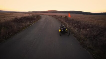 Aerial view of an Adaptive athlete doing a training ride on his handcycle. High quality 4k footage