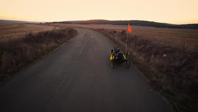 Aerial view of an Adaptive athlete doing a training ride on his handcycle. High quality 4k footage