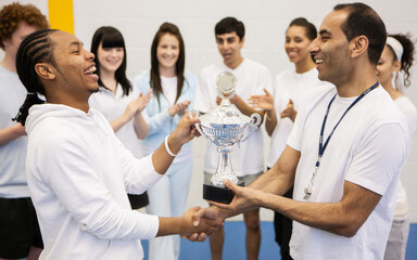 Sports Students: First Prize. A trophy presentation for a teenage sportsman with encouragement from...