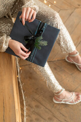 The girl opens the New Year's gift box with gifts, close-up