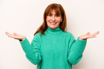 Middle age caucasian woman isolated on white background makes scale with arms, feels happy and confident.