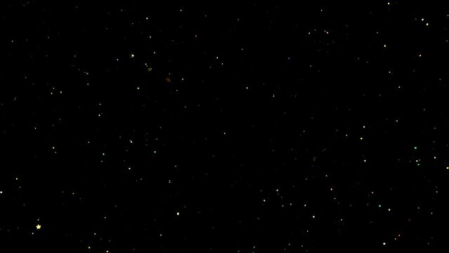 Super slow motion of abstract shiny gold particles on black background. Filmed on high speed cinematic camera at 1000 frames per second.