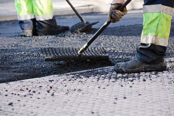 asphalt in the city operators working with uniform