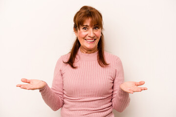 Middle age caucasian woman isolated on white background makes scale with arms, feels happy and confident.