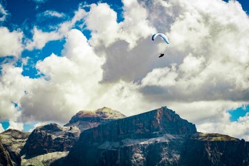 Paragliding man with rocky mountains dolomites trentino paraglider on the background, Italy