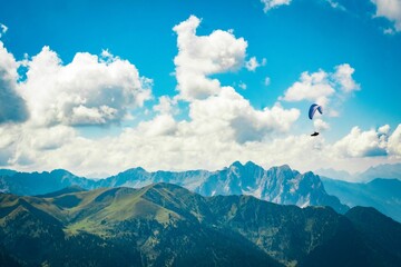 Paragliding man with rocky mountains dolomites trentino paraglider on the background, Italy
