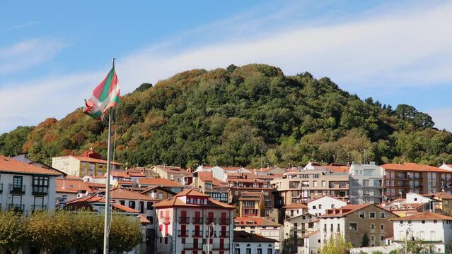 Colorful buildings in fishing village of Mundaka with Basque flag, Basque Country, Spain