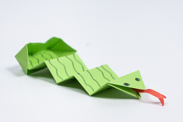 Origami green snake, DIY paper crafts, white background