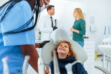 Cheerful child in dentist's chair.