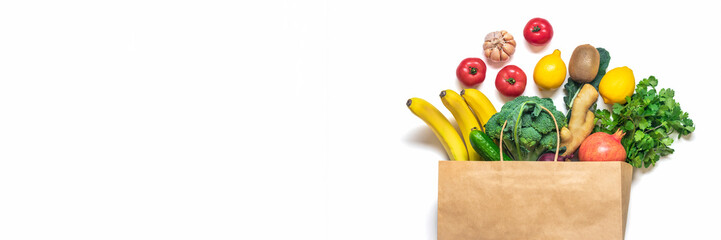 Eco friendly paper shop bag with raw organic green vegetables isolated on white background Flat lay, top view Zero waste, plastic free concept Healthy clean eating diet and detox, agriculture concept