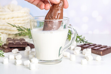 Making winter hot cocoa drink, preparation funny Christmas hot chocolate with milk and chocolate Santa figure, christmas diy lifehack recipe