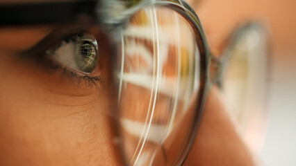 Obraz premium Business woman looking for content in stock video and photos. Stock content reflection on eyeglases from pc screen. Business marketing for companies.