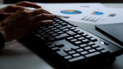 Business woman working late at office at computer typing on keyboard. Business financial accounting concept. Female using computer for financial reports, working late overtime