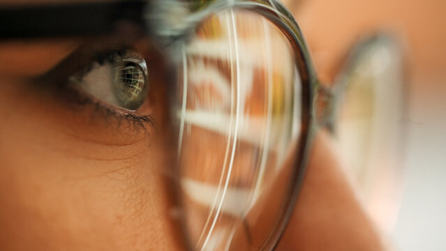 Business woman looking for content in stock video and photos. Stock content reflection on eyeglases from pc screen. Business marketing for companies.