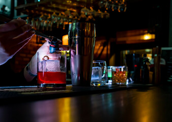 woman hand bartender making negroni cocktail in bar
