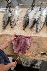 filletting fish  at covered market, Funchal, Madeira