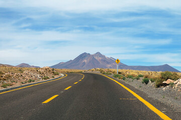 Curvy Road Signpost on the Empty Desert Road in Atacama Desert, Antofagasta Region, Northern Chile, South America