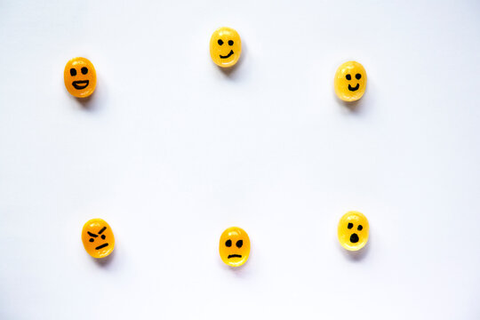 Yellow Candies With Painted Emoji Faces Ot It On The White Background