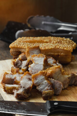 crispy pork belly deep fried pork or Chinese roasted pork belly on a wooden chopping board. close-up shot