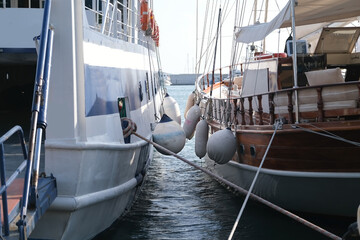 Two yachts with Inflatable balls for docking stand side by side in the port