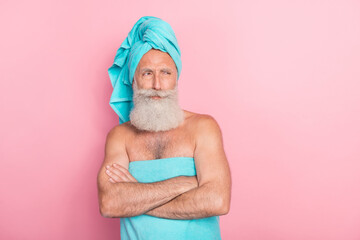 Photo of suspicious retired man with crossed man look empty space spa center procedure isolated on...