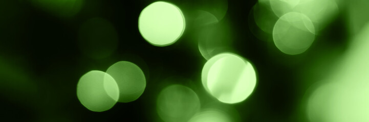 Blurred lights, green background, banner texture. Abstract bokeh with soft light header. Wide...