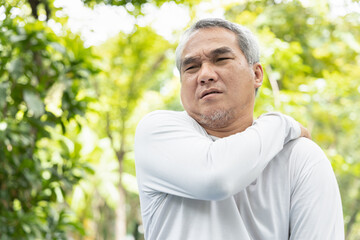 Asian old senior man suffers from shoulder joint pain, osteoporosis, loss of bone mass