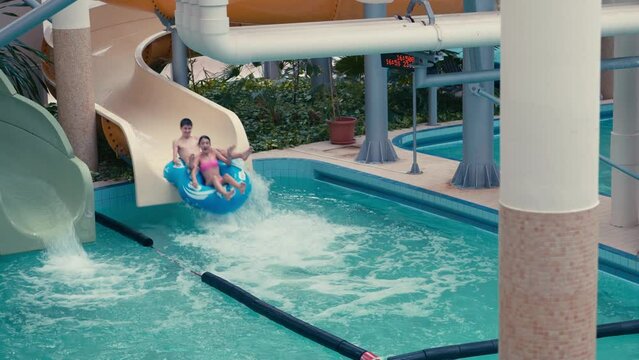 Girl And Boy On A Water Slide