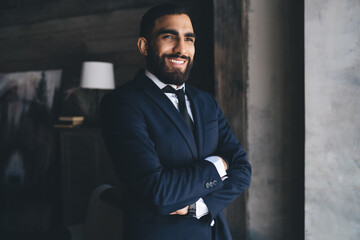 Confident ethnic businessman with arms folded