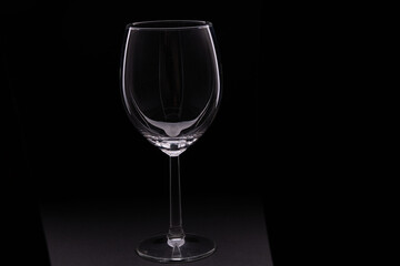 photo of an empty wine glass on a black background