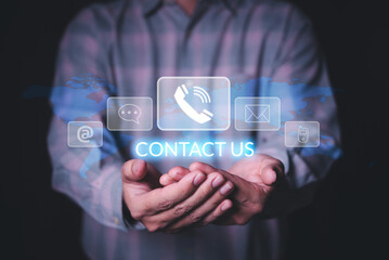 man hand holding contact icons for call support on virtual screen , man select customer support channel (telehpone, mobile , email or chat message)
