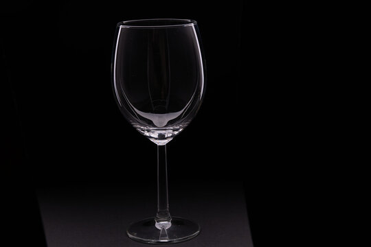 photo of an empty wine glass on a black background