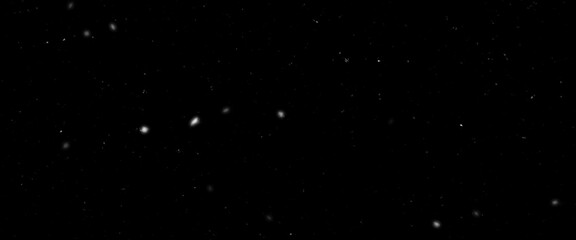 Falling snow isolated on black background. Falling snow at night. Bokeh lights on black background, flying snowflakes in the air. Winter weather. Overlay texture.