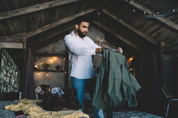 Bearded man checking out jacket