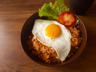 Fried Rice with half-cooked sunny egg on top in a bowl