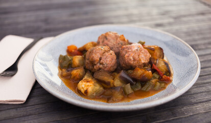 cooked meatballs with stewed eggplant with haze in bowl