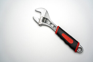Adjustable wrench with red plastic handle isolated on white, mechanic tools such as construction work, garages,and other mechanic work, the wrench that can be adjusted according to the desired size