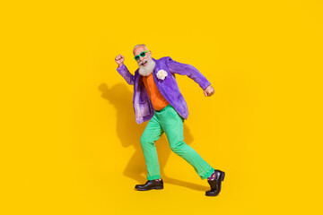 Full length photo of nice granddad celebrate weekend holiday dancing dressed stylish colorful outfit isolated on yellow color background